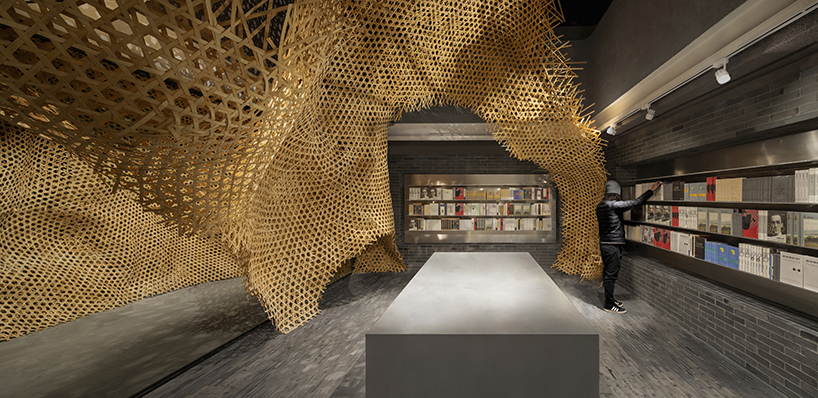 weaved bamboo installation by infinity mind extends within bookstore in shanghai