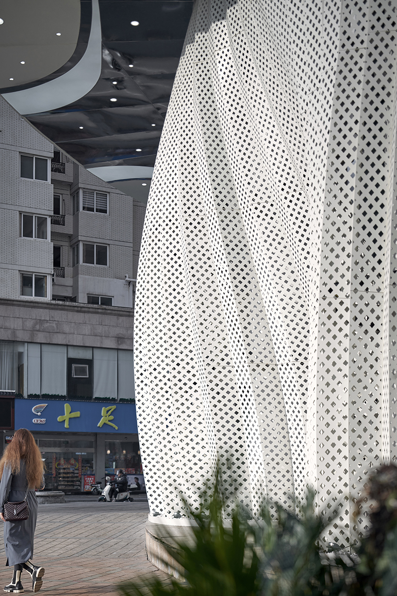 antistatics architecture echoes rippling fabric in perforated metal at wedding center in china