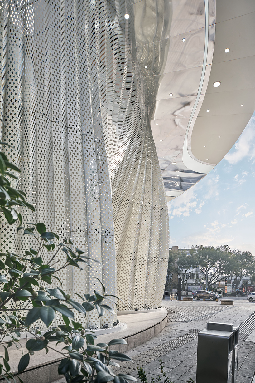 antistatics architecture echoes rippling fabric in perforated metal at wedding center in china