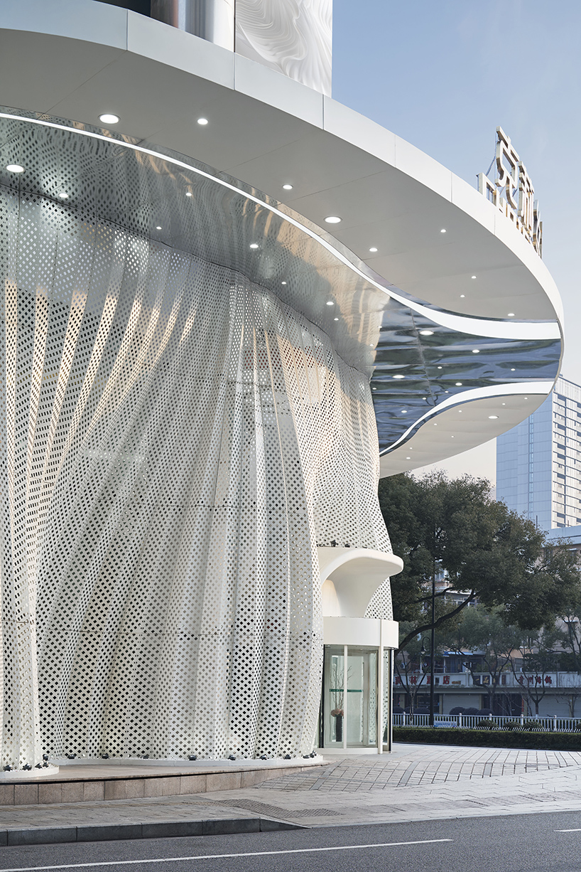 antistatics architecture echoes rippling fabric in perforated metal at wedding center in china