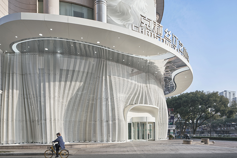 antistatics architecture echoes rippling fabric in perforated metal at wedding center in china