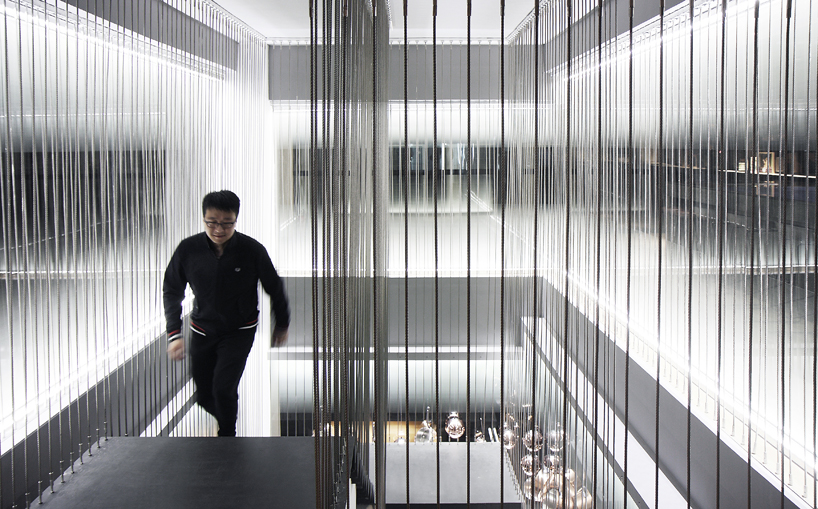 kitchen L by XU studio is a flexible shanghai restaurant decorated with copper kitchenware