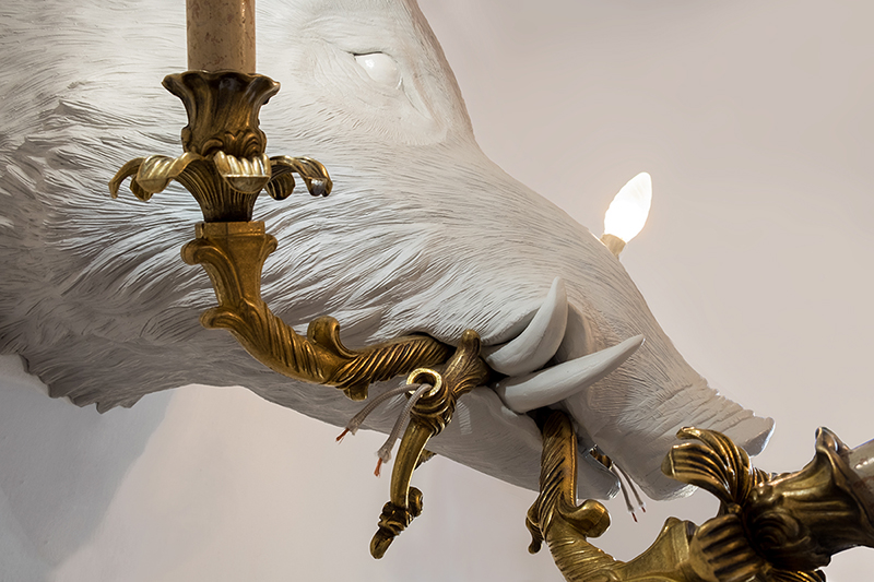 marcantonio's instinct illumination series depicts creatures holding ripped chandeliers