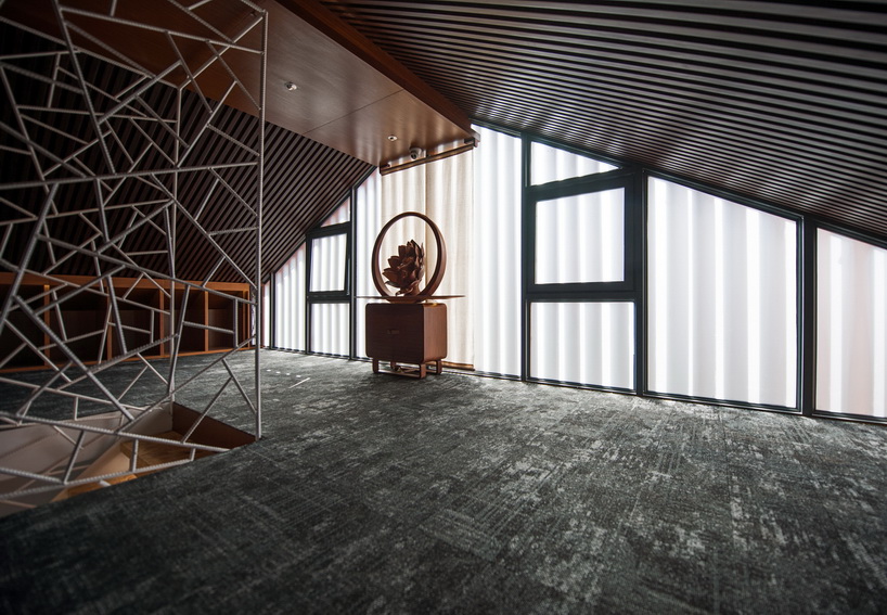 cracked ice-patterned fence by minax encases one buddha's room's staircase