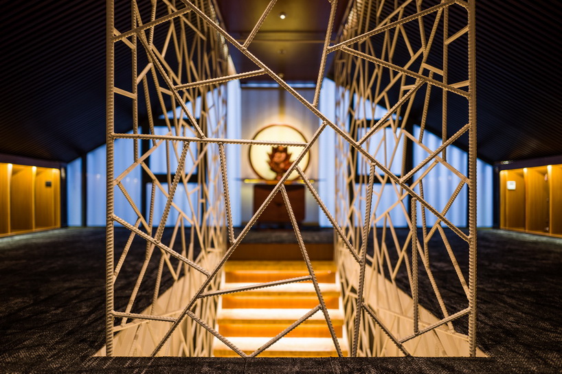 cracked ice-patterned fence by minax encases one buddha's room's staircase