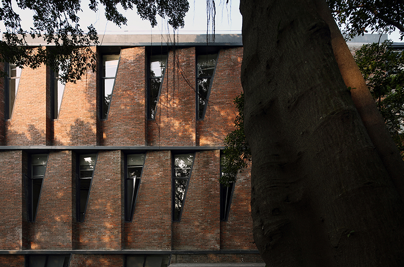 red brick facade with angular windows enfolds multi-use building in china's art district