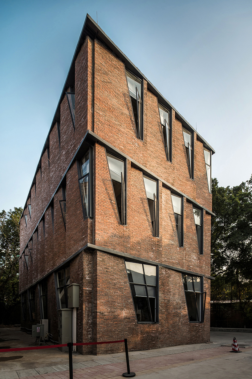 red brick facade with angular windows enfolds multi-use building in china's art district