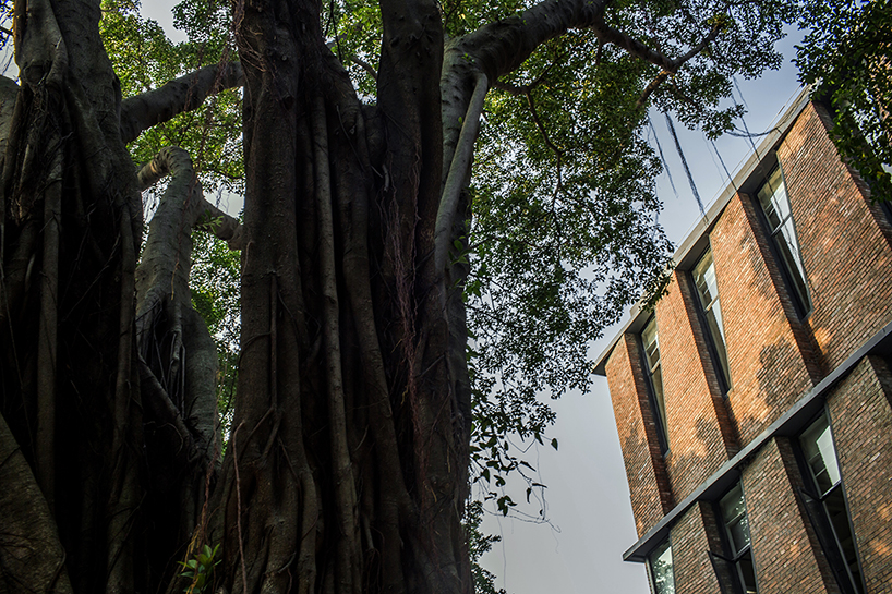 red brick facade with angular windows enfolds multi-use building in china's art district