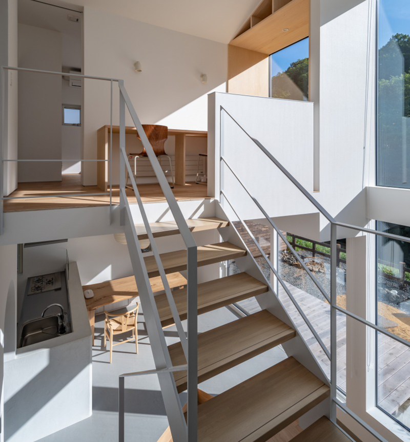 split-level timber house organizes layered interiors around japanese forest landscape - 6