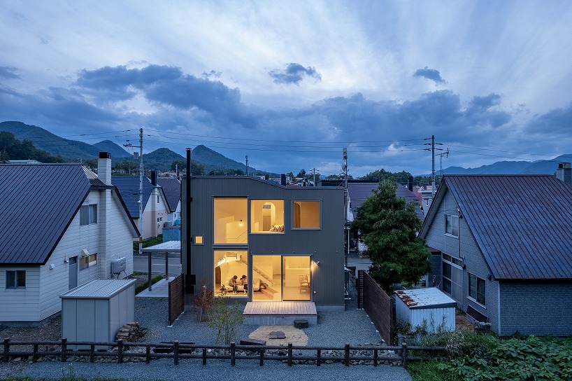 split-level timber house organizes layered interiors around japanese forest landscape - 8