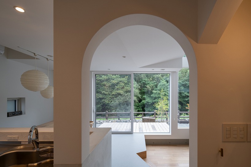 split-level timber house organizes layered interiors around japanese forest landscape - 4