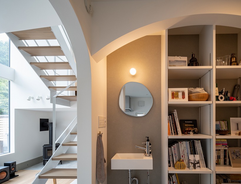 split-level timber house organizes layered interiors around japanese forest landscape - 7