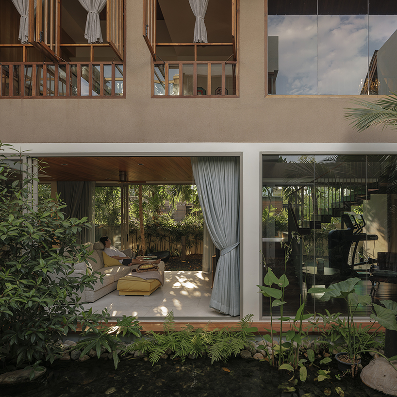 cedar shingle roof crowns tropical residence with green courtyard in thailand