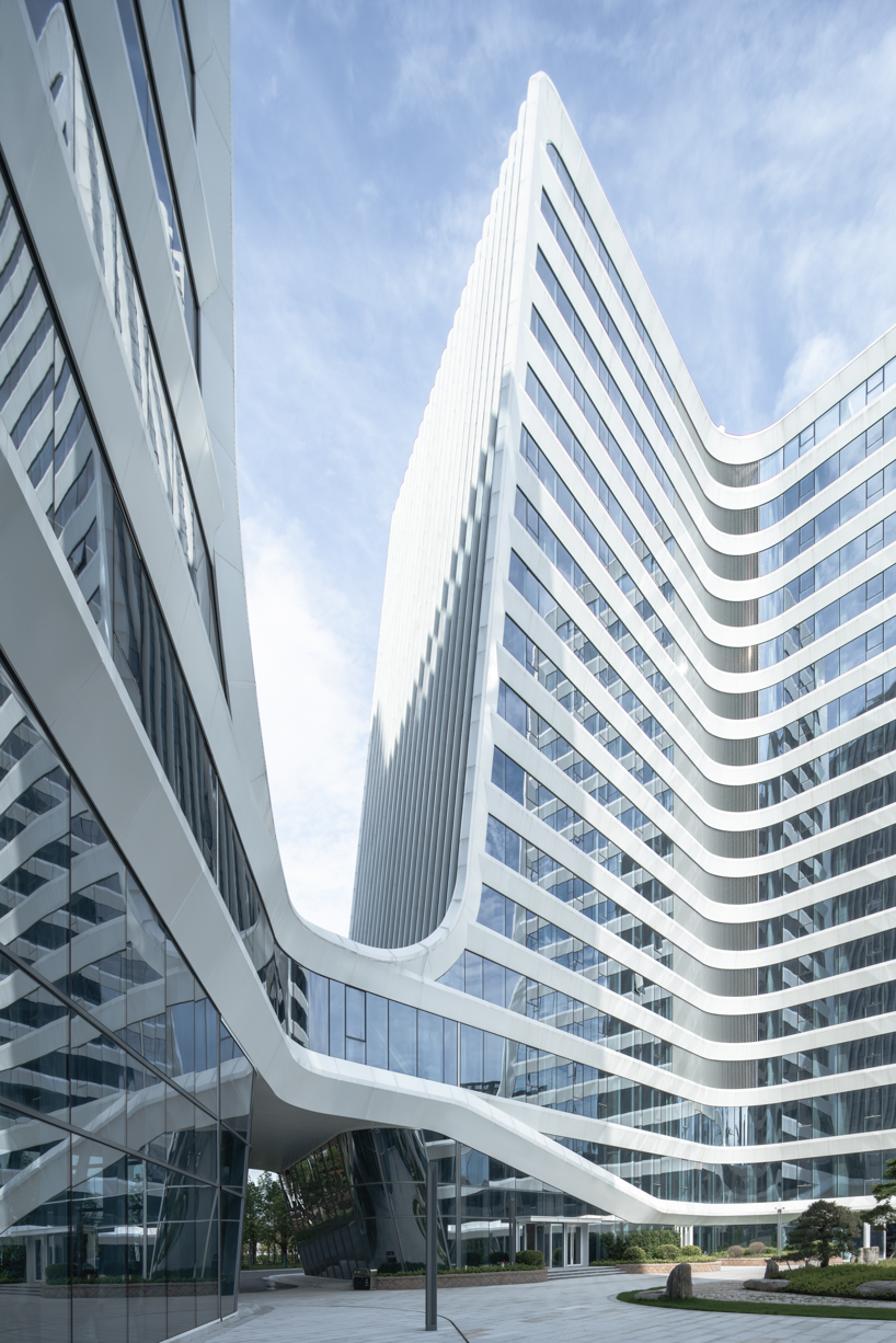 curving towers of LYCS architecture's mixed-use complex echo ripples of wulong river, china
