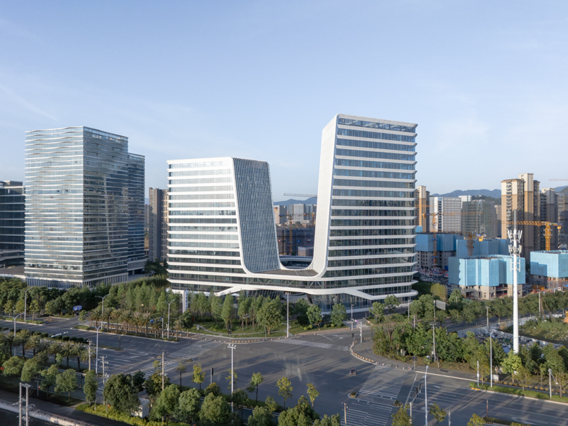 curving towers of LYCS architecture's mixed-use complex echo ripples of wulong river, china