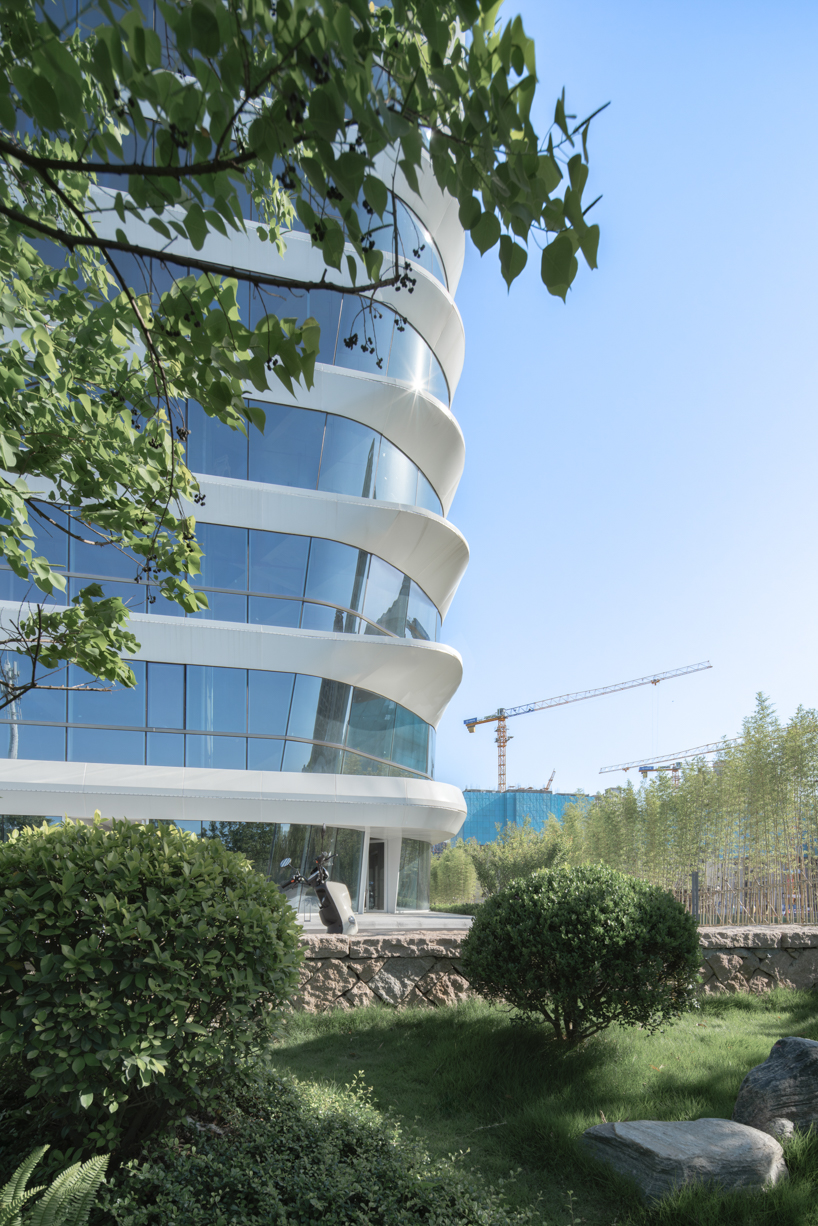 curving towers of LYCS architecture's mixed-use complex echo ripples of wulong river, china