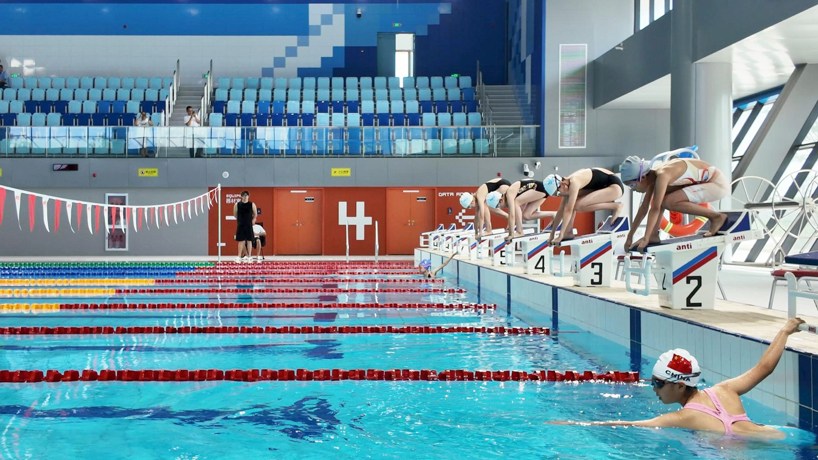 scale-like facade wraps hushan swimming center's undulating form by LYCS architecture