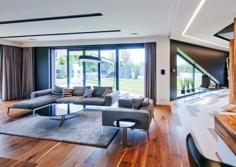 reform architekt's triangular house in poland perfectly fits surrounding environment