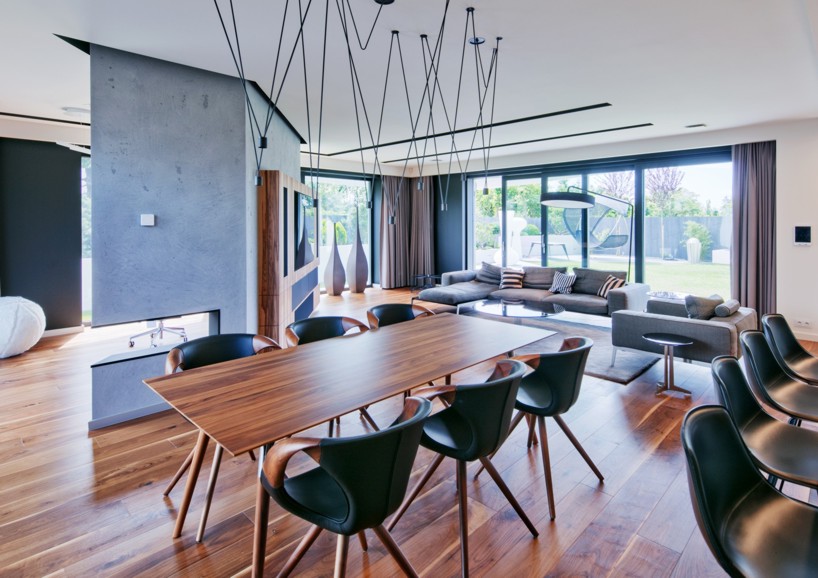 reform architekt's triangular house in poland perfectly fits surrounding environment