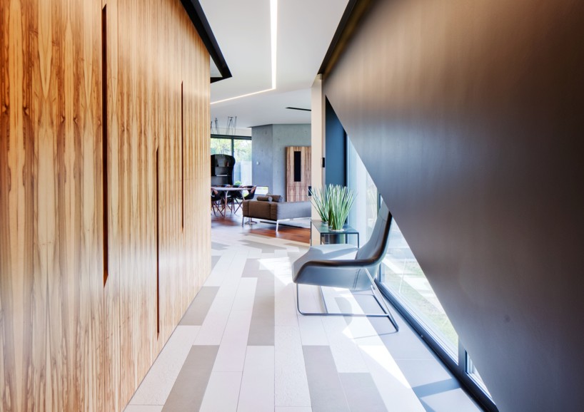 reform architekt's triangular house in poland perfectly fits surrounding environment