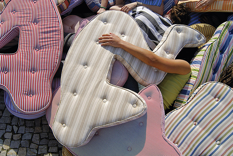 heleno bernardi scatters fetal-shaped mattresses in public spaces all over the world