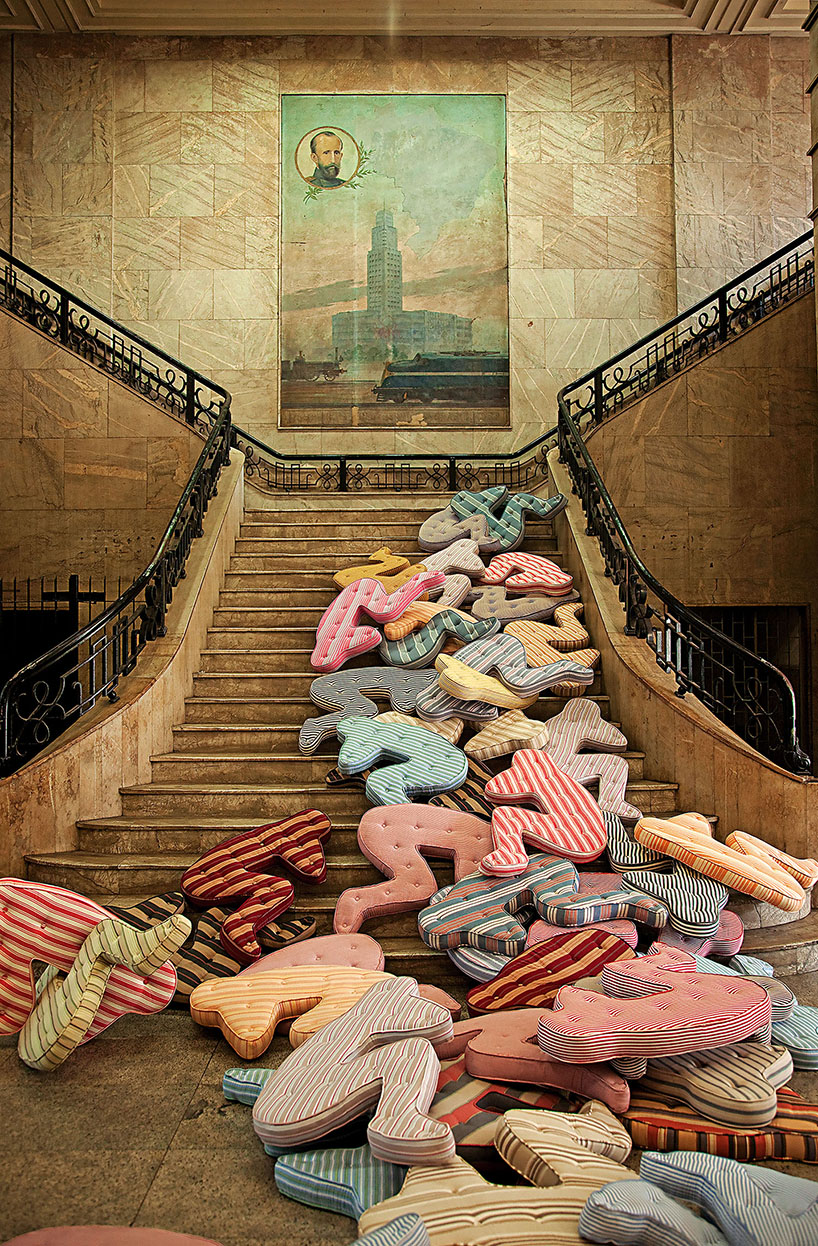 heleno bernardi scatters fetal-shaped mattresses in public spaces all over the world