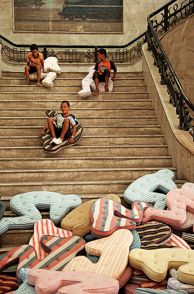 heleno bernardi scatters fetal-shaped mattresses in public spaces all over the world