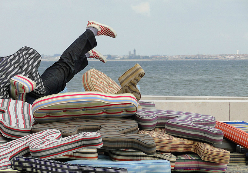 heleno bernardi scatters fetal-shaped mattresses in public spaces all over the world