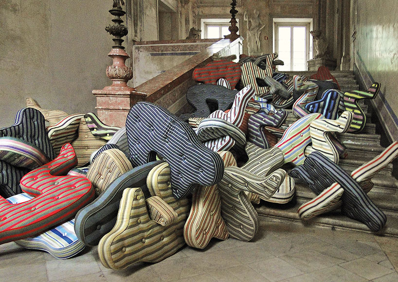 heleno bernardi scatters fetal-shaped mattresses in public spaces all over the world