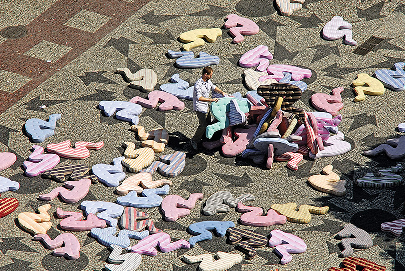 heleno bernardi scatters fetal-shaped mattresses in public spaces all over the world