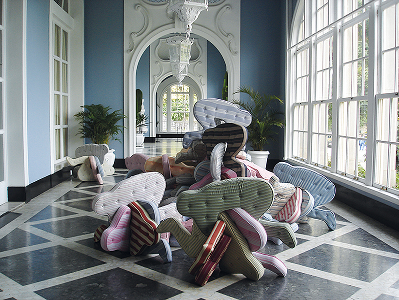 heleno bernardi scatters fetal-shaped mattresses in public spaces all over the world