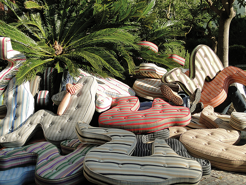 heleno bernardi scatters fetal-shaped mattresses in public spaces all over the world