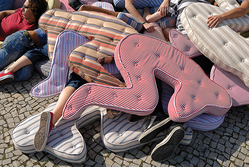 heleno bernardi scatters fetal-shaped mattresses in public spaces all over the world