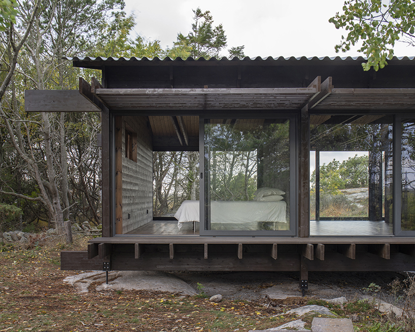 a grid of stained dark planks shapes up wooden cabin in west sweden