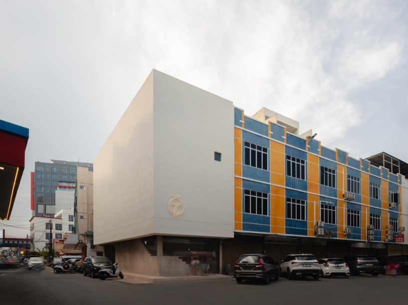 light and rain pour through internal courtyard within monochrome dessert shop in indonesia
