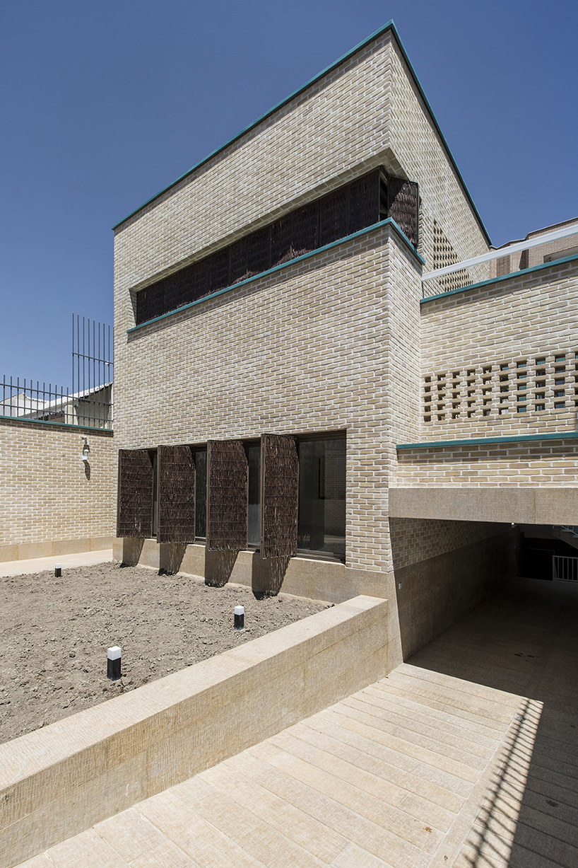 ayeneh office's house in iran takes shape around a central yard clad in blue tiles