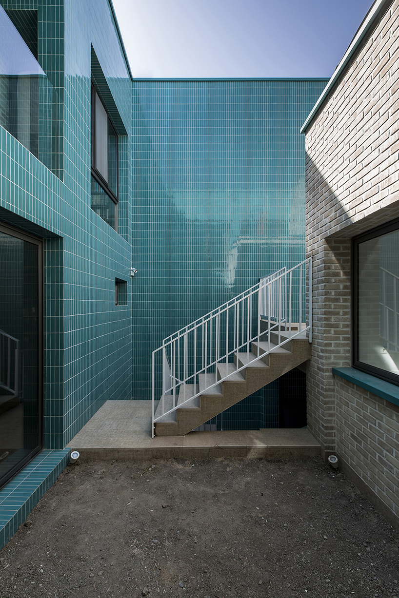 ayeneh office's house in iran takes shape around a central yard clad in blue tiles