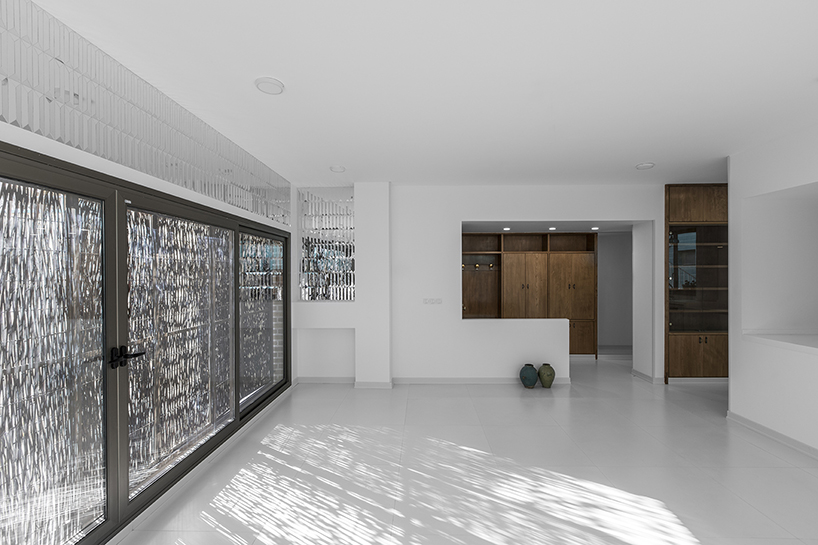 ayeneh office's house in iran takes shape around a central yard clad in blue tiles