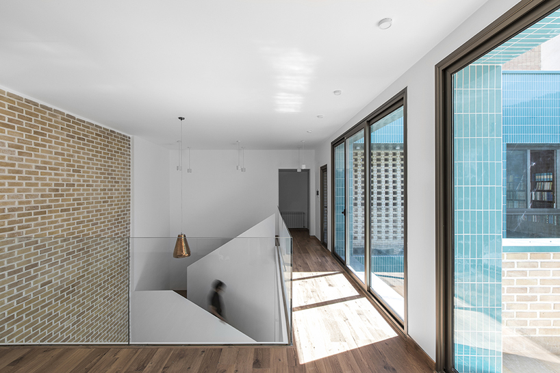 ayeneh office's house in iran takes shape around a central yard clad in blue tiles