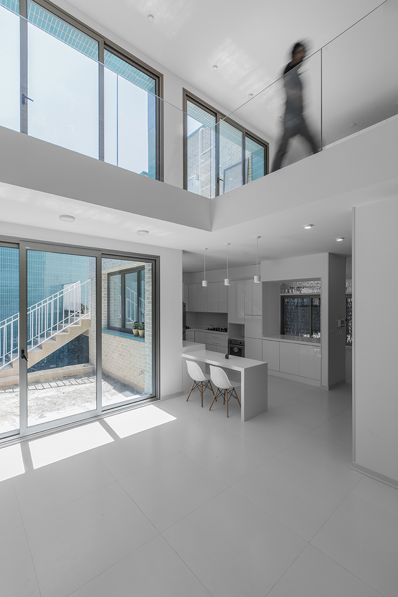 ayeneh office's house in iran takes shape around a central yard clad in blue tiles