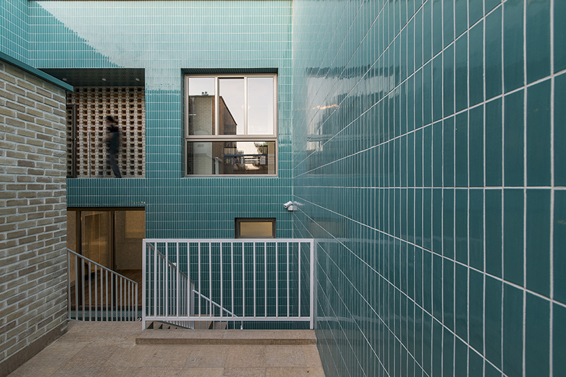 ayeneh office's house in iran takes shape around a central yard clad in blue tiles