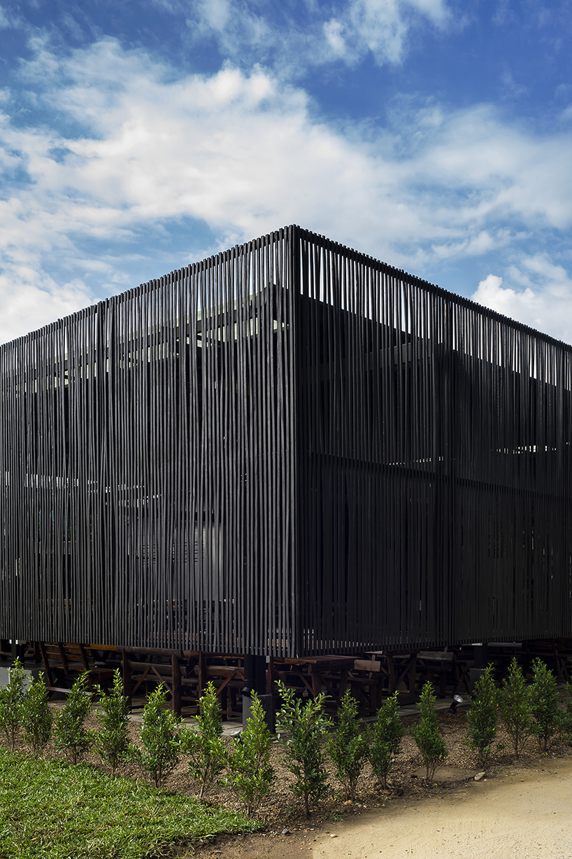 restaurant in thailand by sher maker is covered with charred wood lamellae