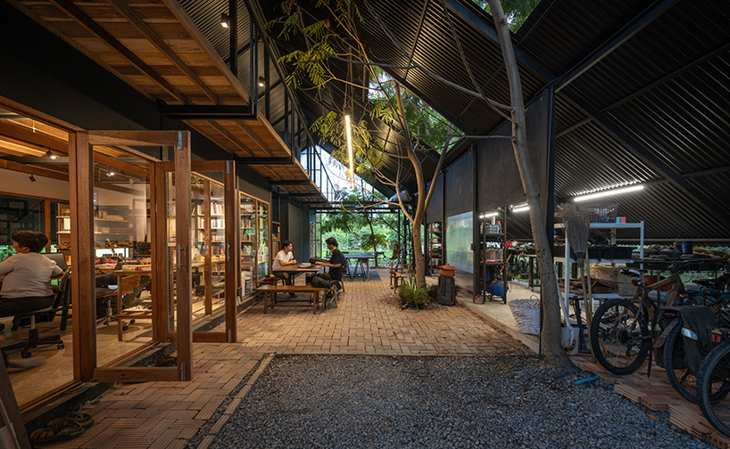 old wooden frames and a steel gable roof construct sher maker's studio in thailand