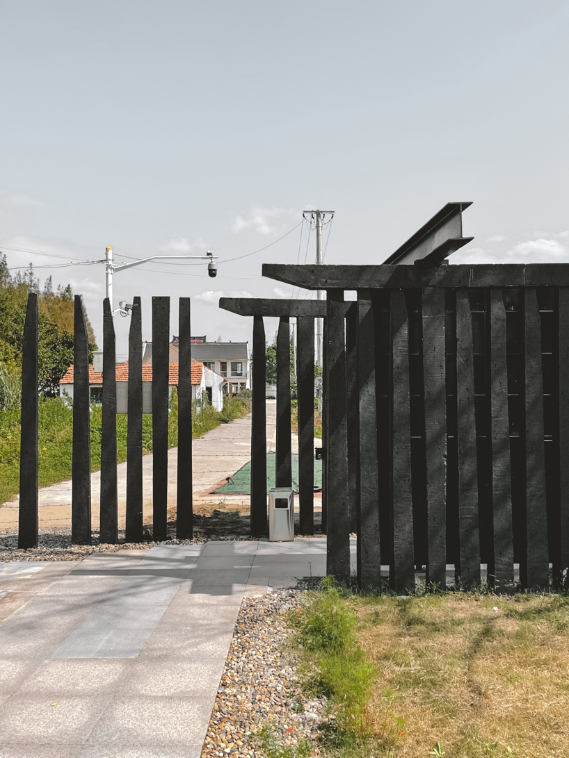 far workshop revives chinese lodge as wine cellar marked by black concrete columns