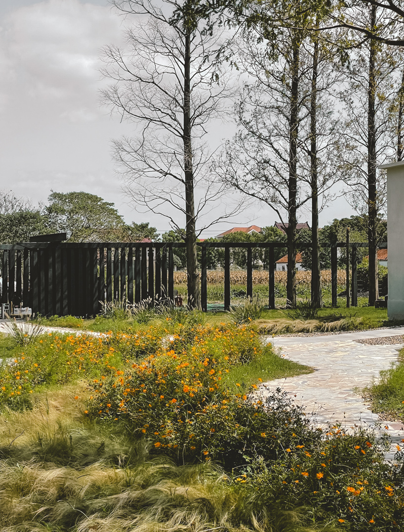 far workshop revives chinese lodge as wine cellar marked by black concrete columns