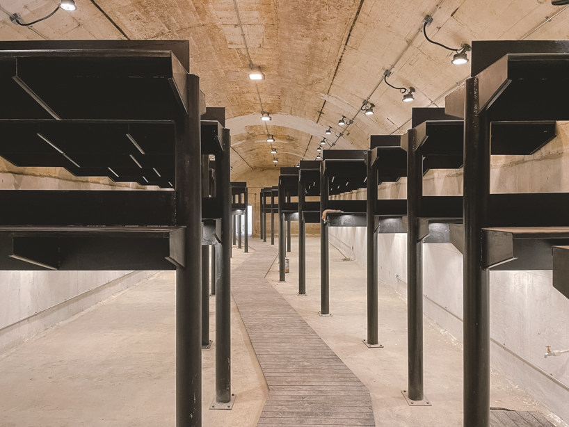 far workshop revives chinese lodge as wine cellar marked by black concrete columns