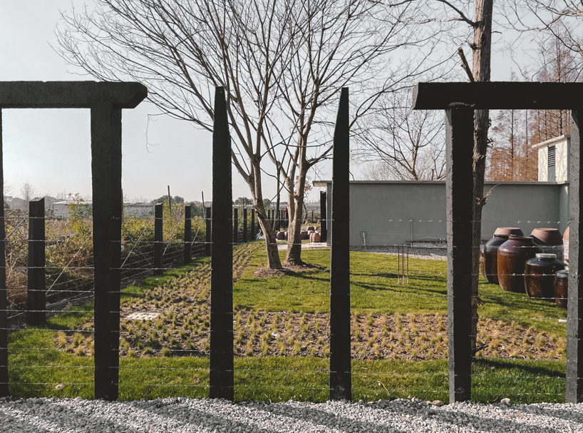 far workshop revives chinese lodge as wine cellar marked by black concrete columns