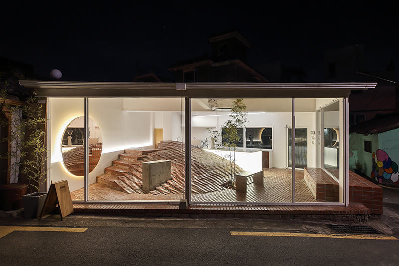 studio maoom replaces standard seating with a 7,000-brick hill in seoul's  coffee nap roasters