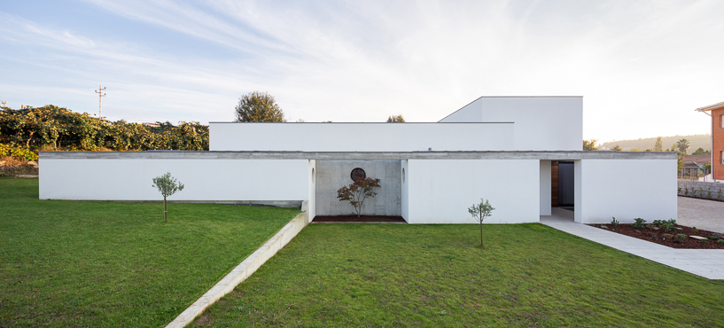exposed concrete structure completes interior materiality of 'casa RM' in portugal