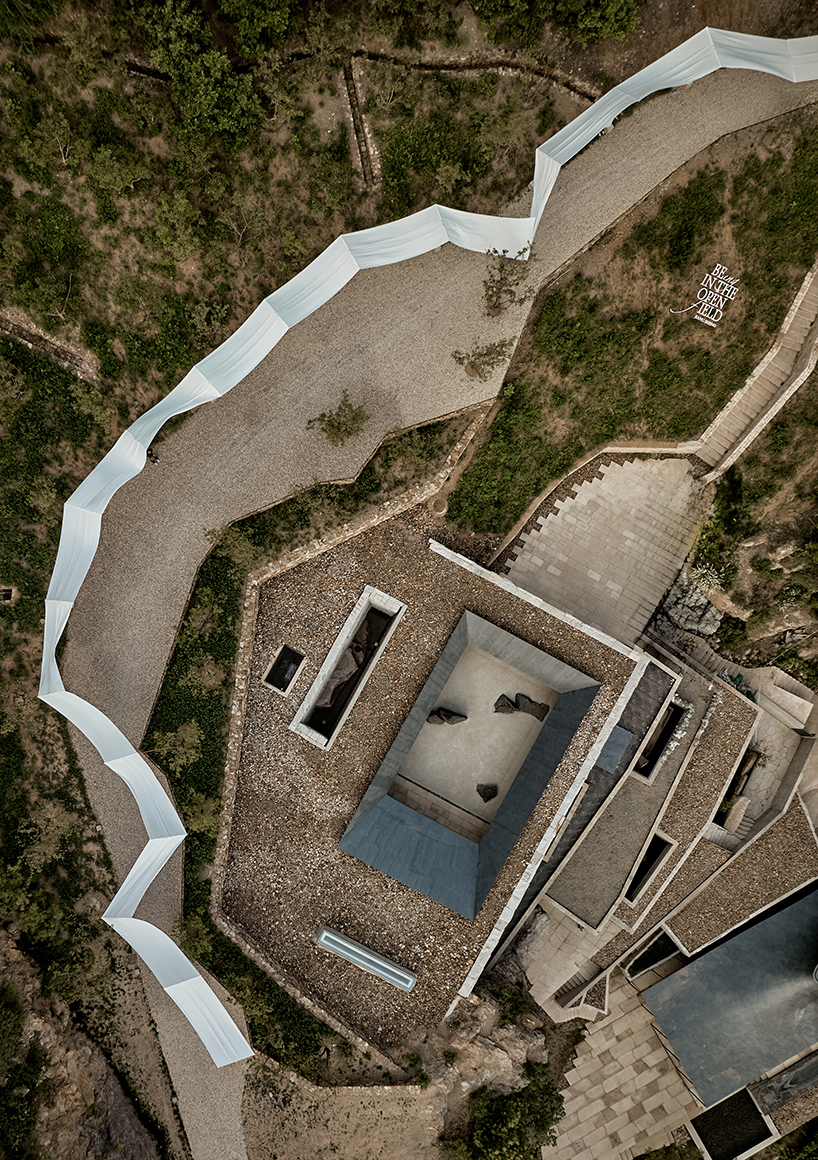 team_bldg's white gauze installation flutters and chimes soft bells in ancient valley in china